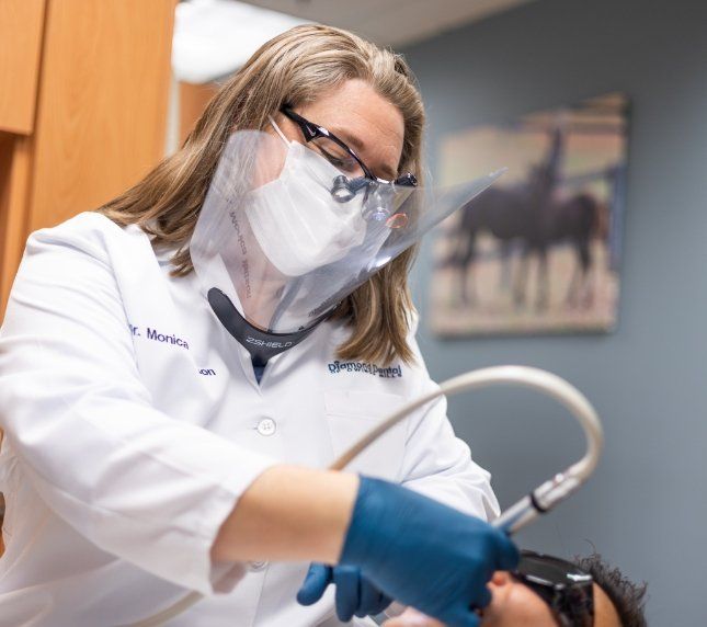 Female dental patient treating patients teeth