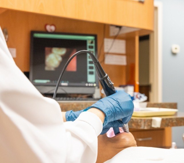 Dentist treating patient with advanced technology