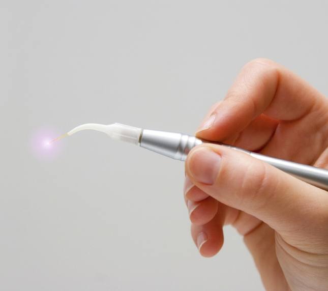 Hand holding soft tissue dental laser