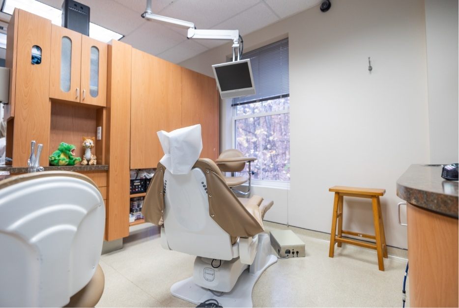 Dental treatment area with stuffed toys on shelf