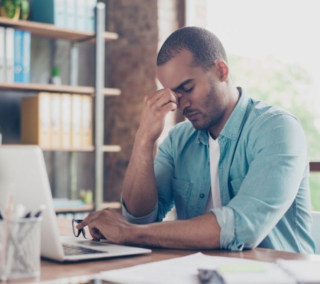 Tired man working on laptop