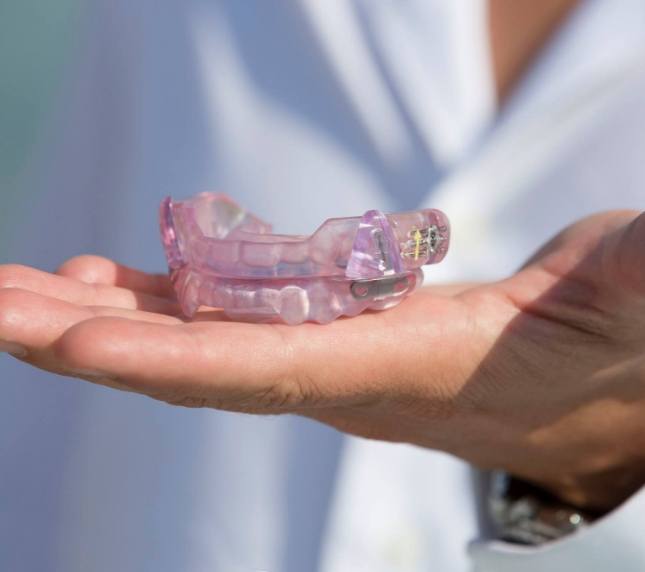 Holding an oral appliance for treating TMJ disorder